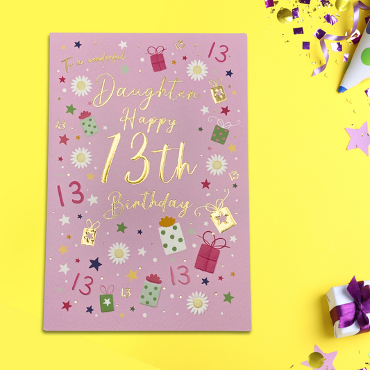 Pink card with gold text and gifts and daisys