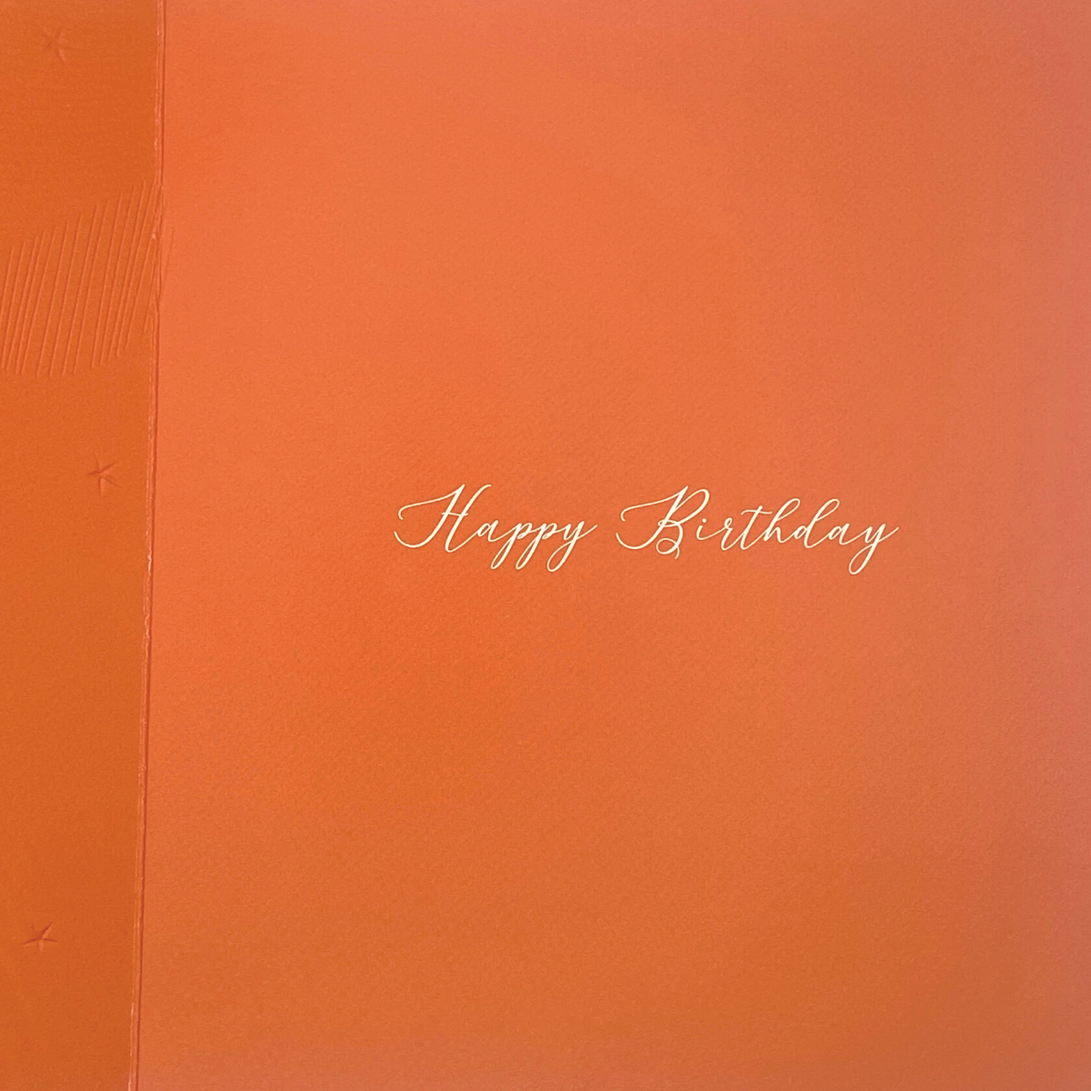 Inside image with bright orange card and white verse