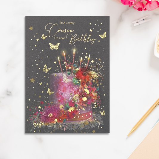 Grey card with pink floral cake with candles and gold foil stars and butterflies