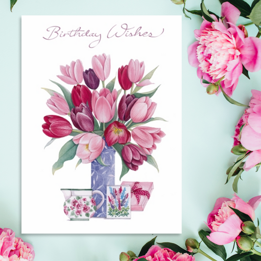 White card with tulips in shades of pink with gifts