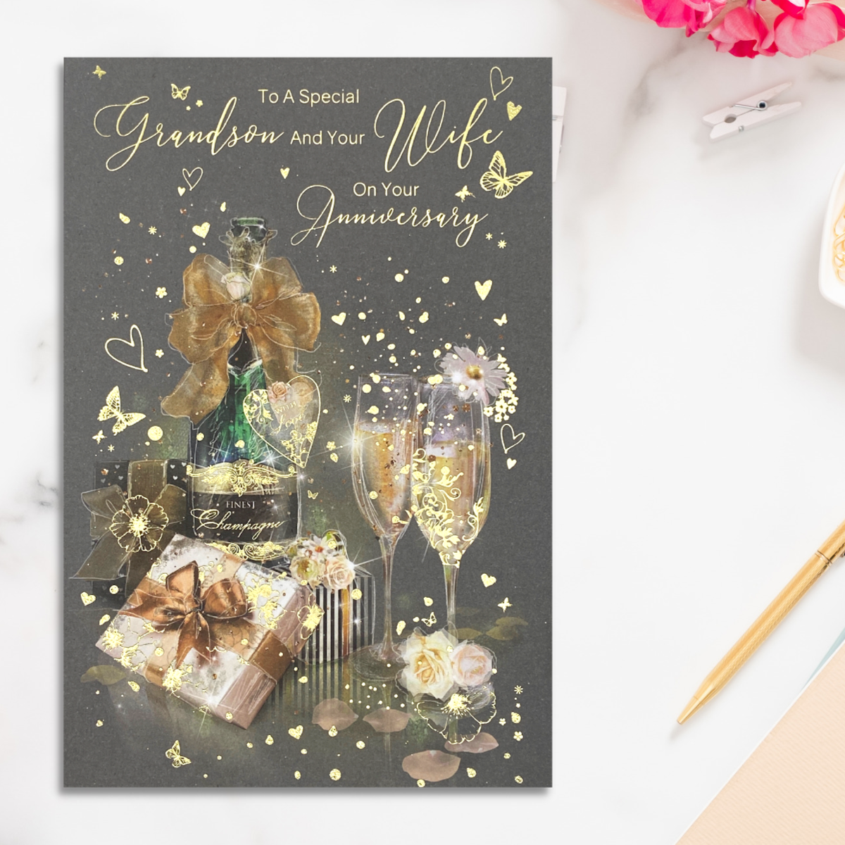 Grey card with bottle of champagne and flutes with gold flowers and hearts