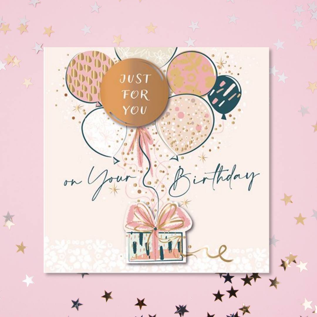 Square pink card with pink, navy and gold foil balloons and gift