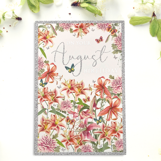 Front image of August birthday card with pretty coral lillies and butterflies