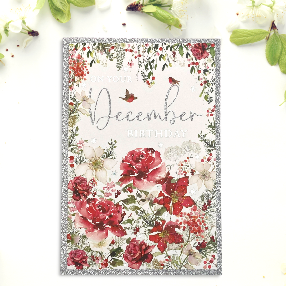 Front image of December card with red flowers and glitter border