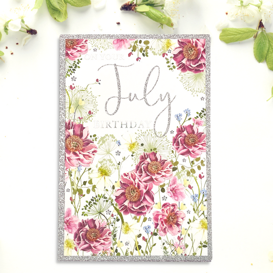 Front image for July Birthday card featuring pretty pink flowers and silver glitter border and text