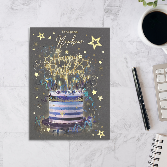 Grey card with a blue and white striped cake and candles. Gold foil text and stars