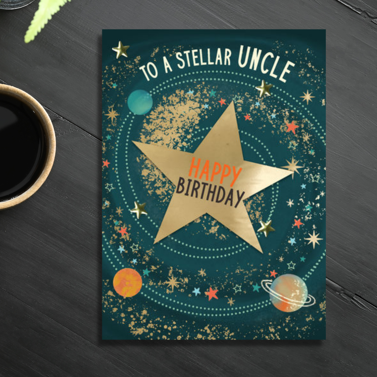 Green card with stars and planets in gold foil