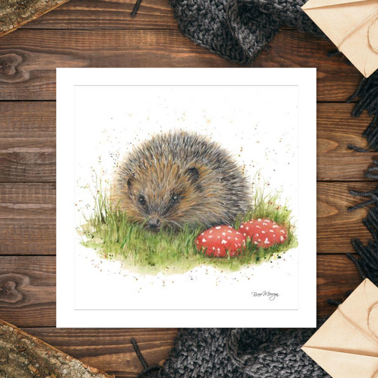Blank card featuring hedgehog with grass and coloured stones