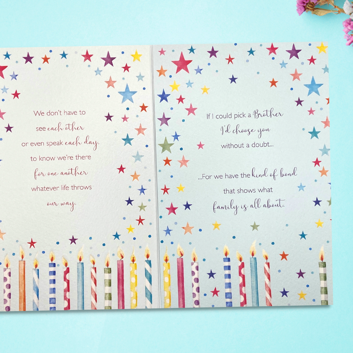 Inside image showing two pages with further candles, stars and verse