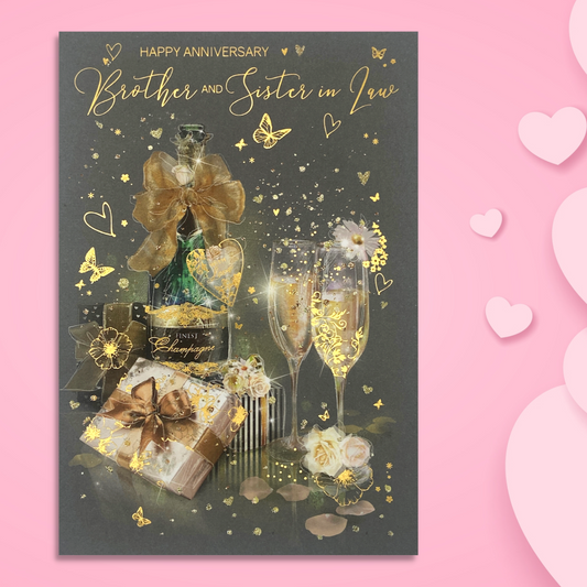 Dark grey card with striking gold foil details with bottle of bubbly, glasses, gifts and butterflies