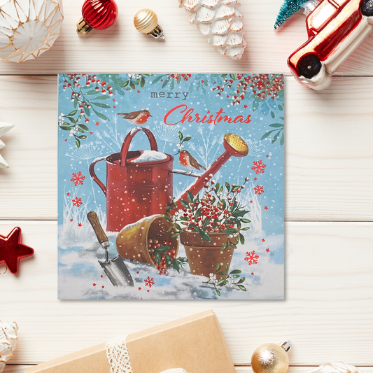 Square card with red watering can, flower pots in snow and robin