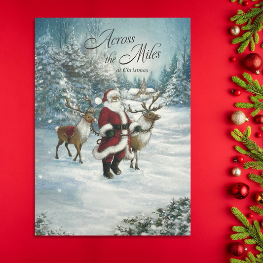 Front image with santa and two reindeer in snow