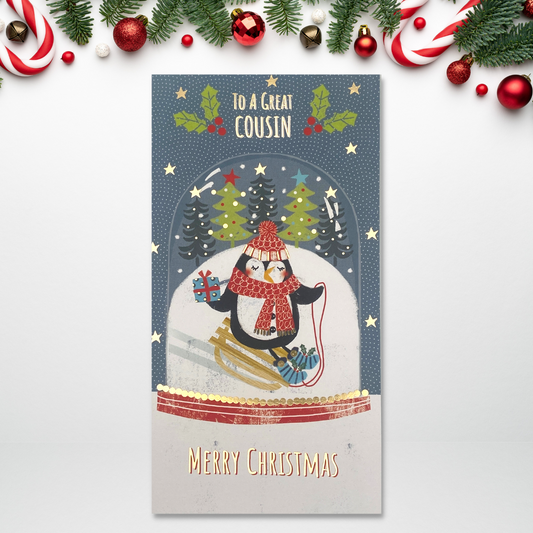 Slim card with penguin sledging inside snow globe