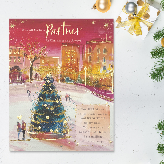 Brightly coloured red theme card with Christmas tree street scene with couples walking and verse