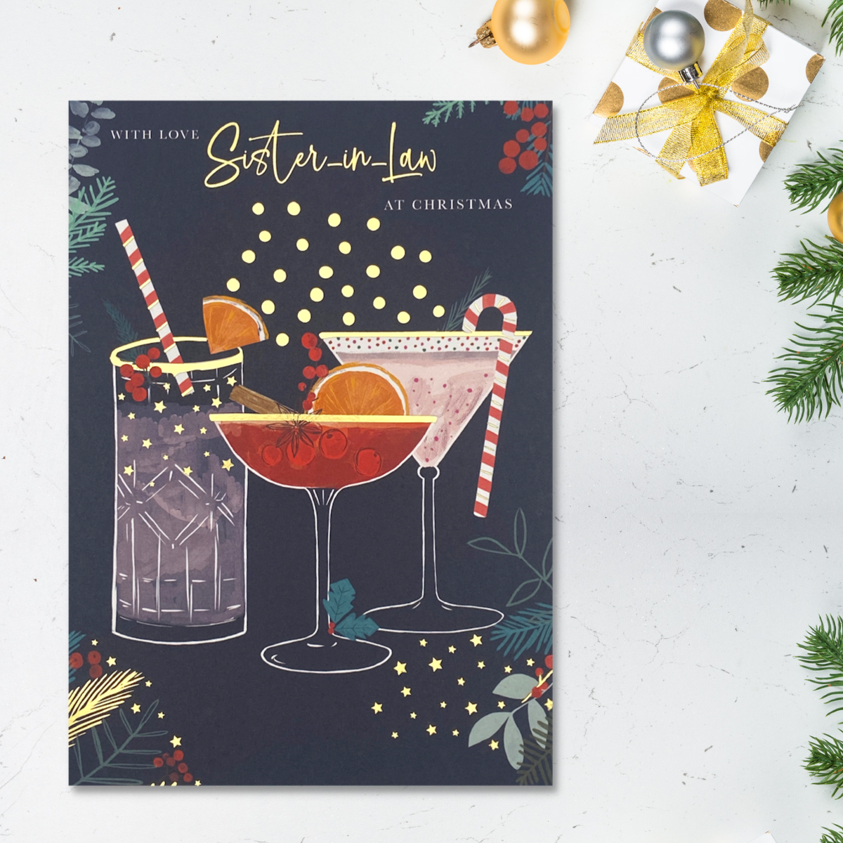 Dark card with three cocktails and festive foliage with gold foil details