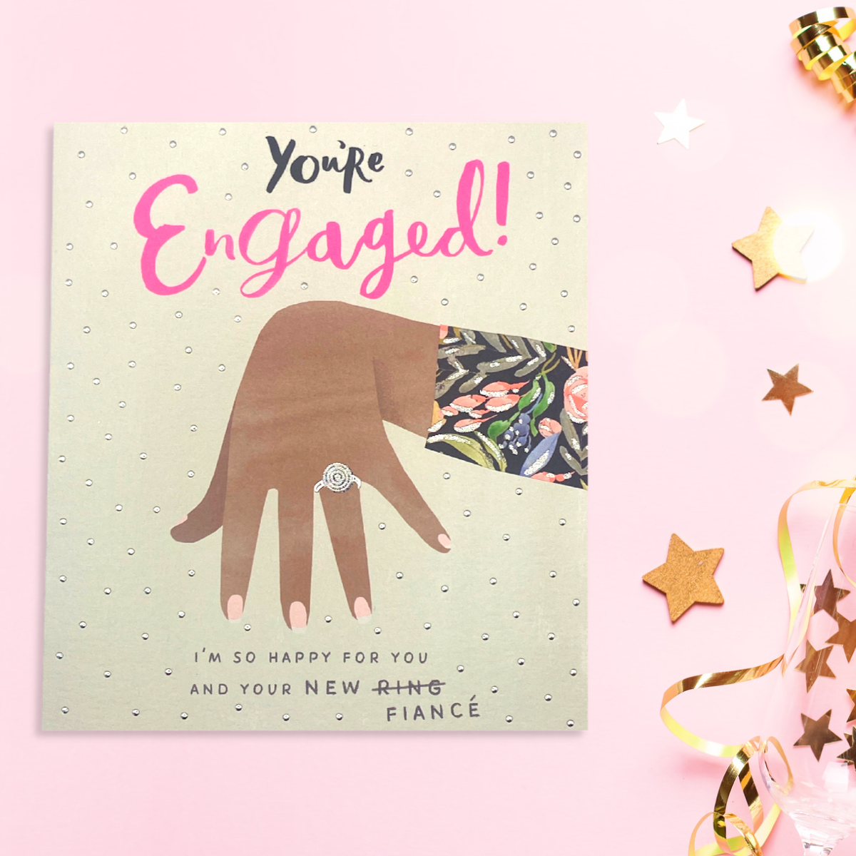 Front image of engagement card showing hand with ring on, neon text