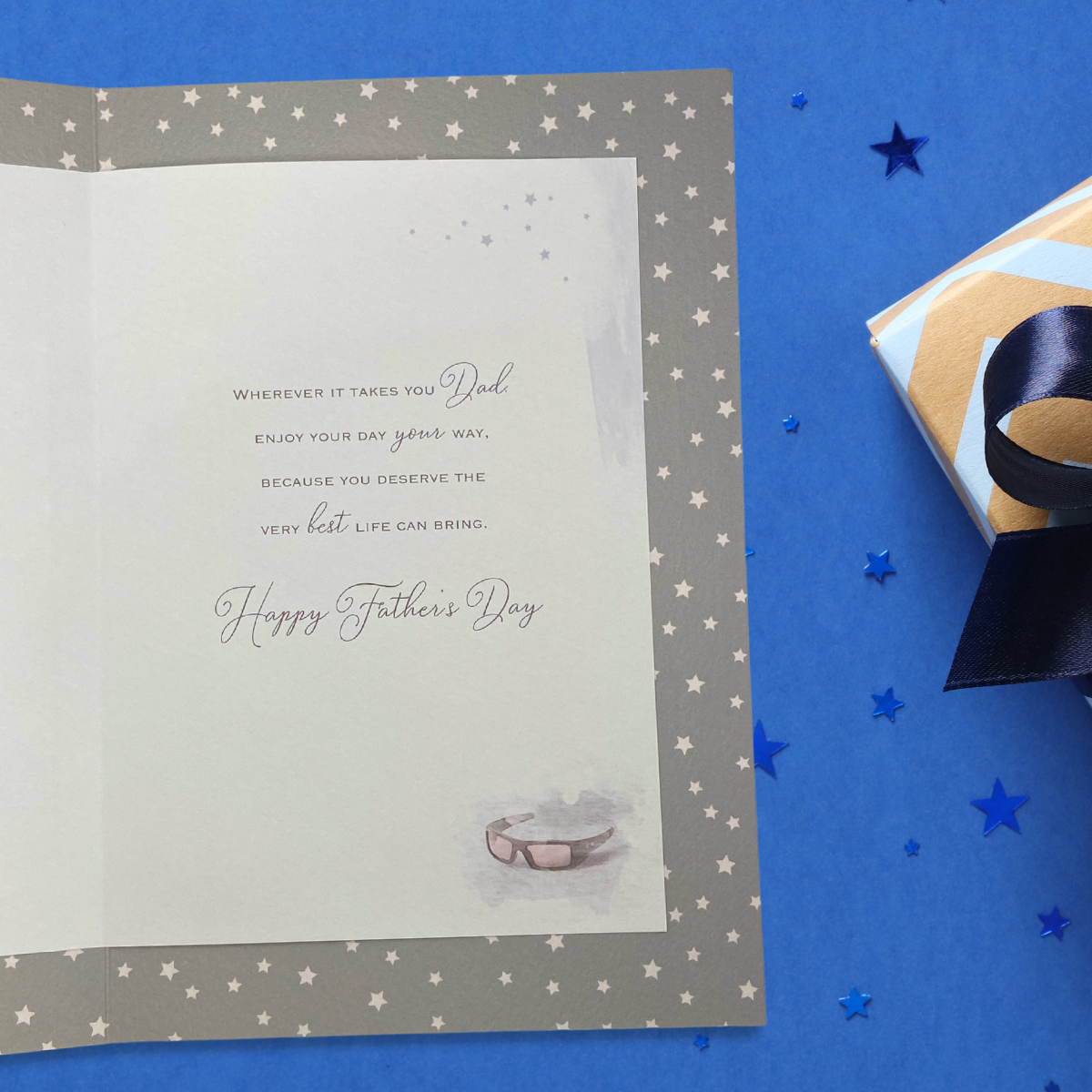 inside showing grey card with white stars and colour printed insert with verse and sunglasses