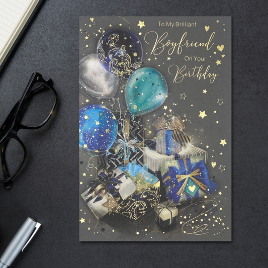 Striking grey card with bright blue and silver balloons and gifts with gold foil details