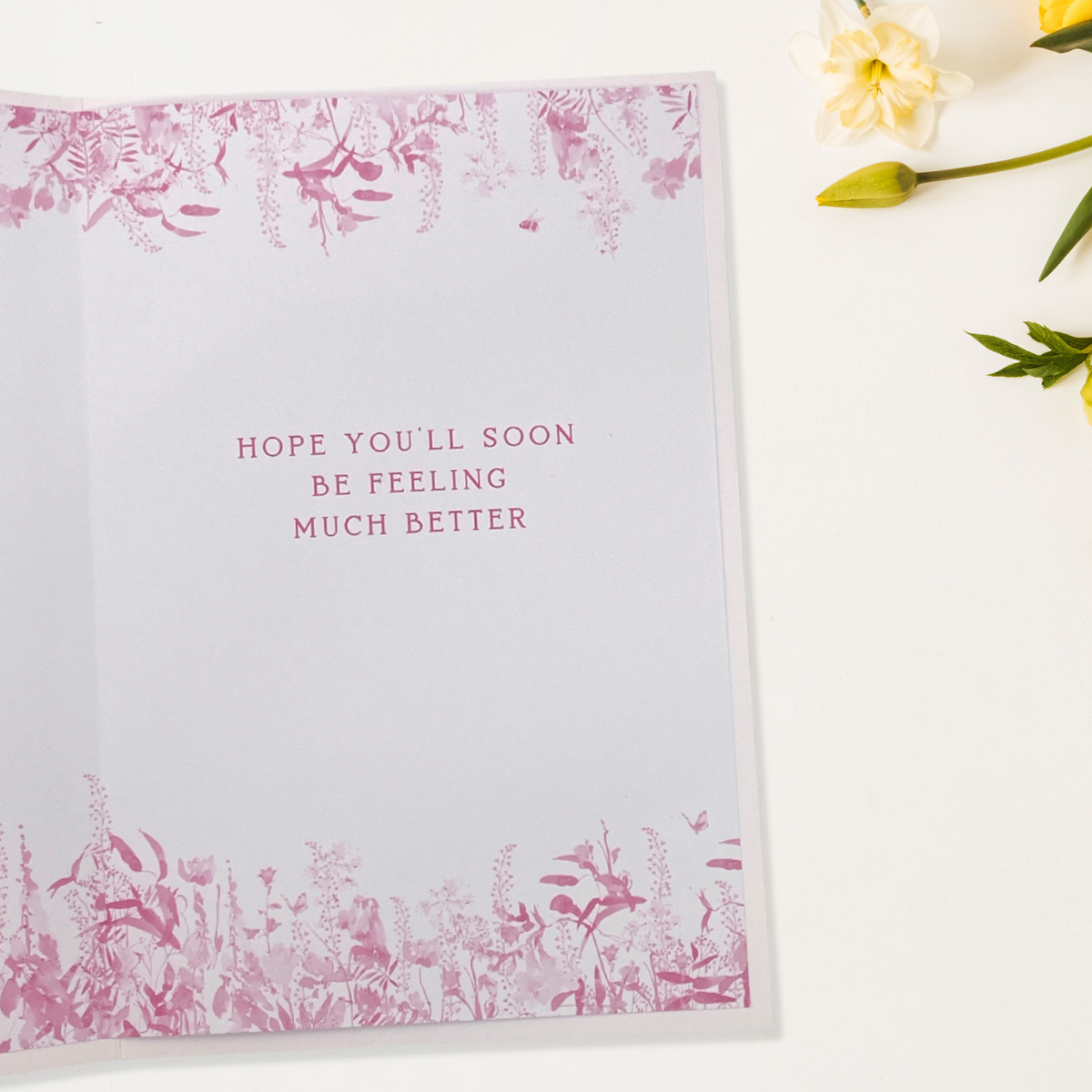inside image with pink flowers and text