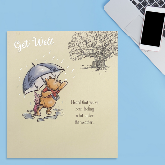 Front image showing winnie the pooh and piglet sheltered under an umbrella