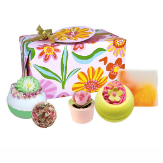 Giftwrapped bath bomb gift set with floral paper and gold ribbon