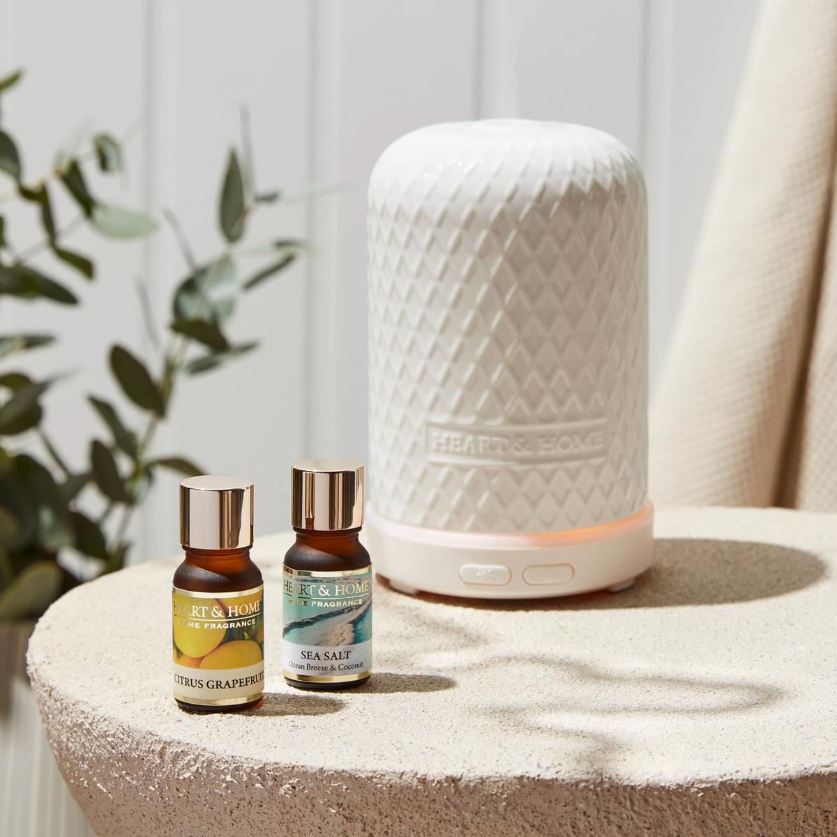 Lifestyle image with aroma diffuser and selection of oils