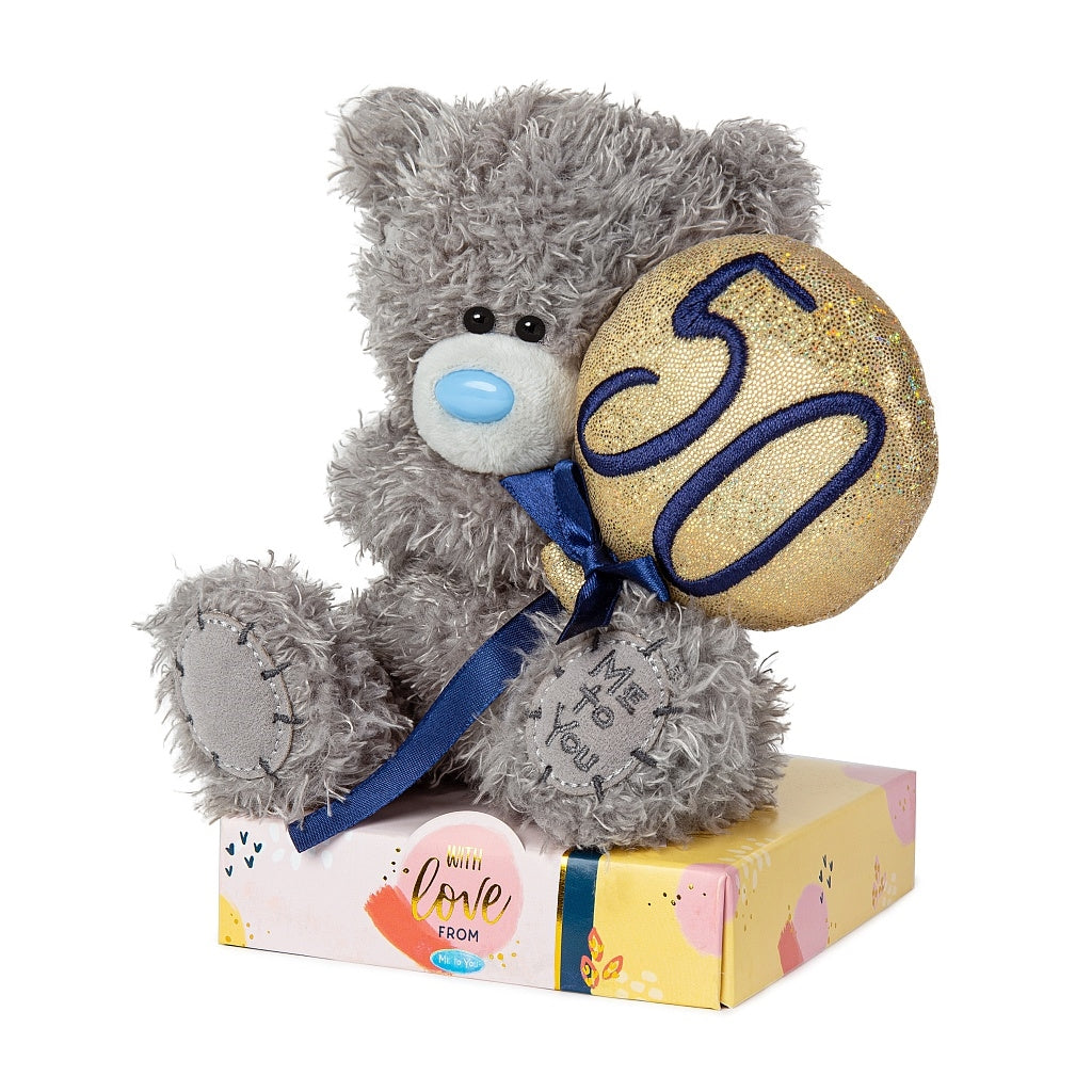 Tatty Teddy holding gold and blue 50th Balloon