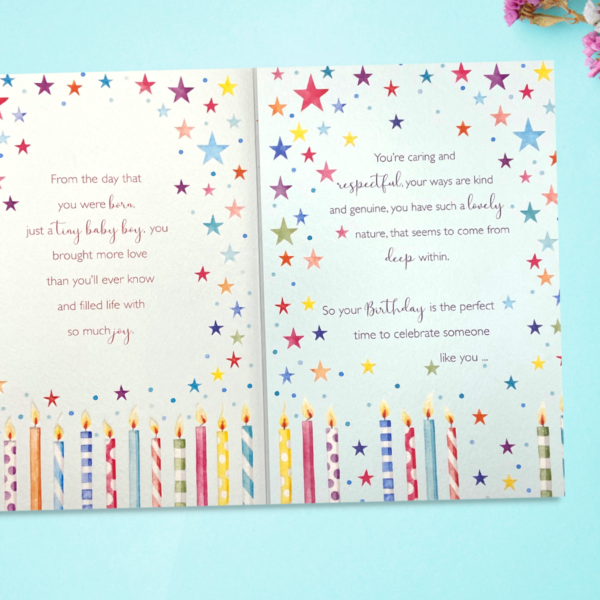 Inside image with two pages with stars, candles and verse