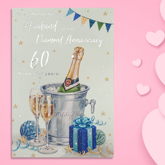 Front design with champagne bucket, bubbly, flutes and gift with blue decorations and bunting