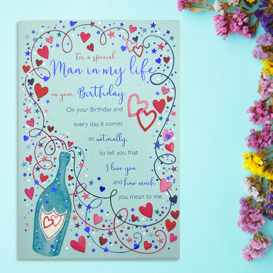 Blue card with red and blue heart border with champagne bottle