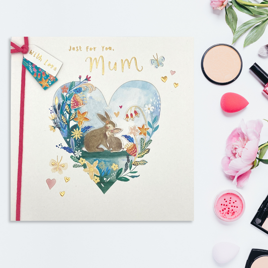 White square card with bunnies embraced inside a decorated floral heart