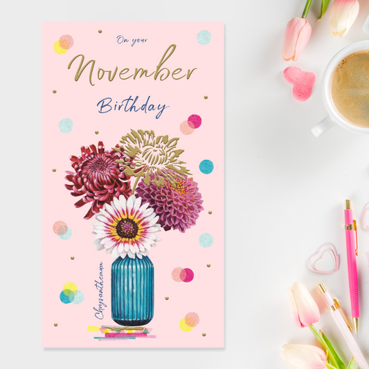Slim pink card with blue vase filled with chrysanthemums