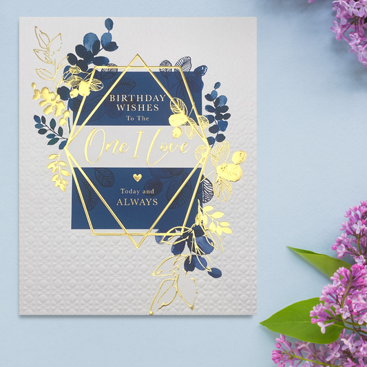 White and navy theme card with gold floral hexagon and embossed card details