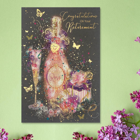 Stunning retirement card, pink bubbly, gift and butterflies with gold sparkle on dark background