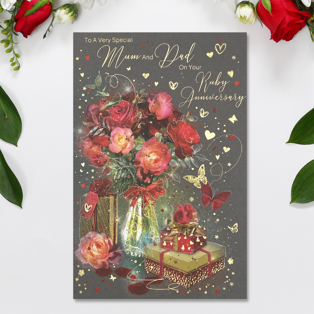 Grey card with red flowers in vase, with wrapped gifts in gold and red and hearts