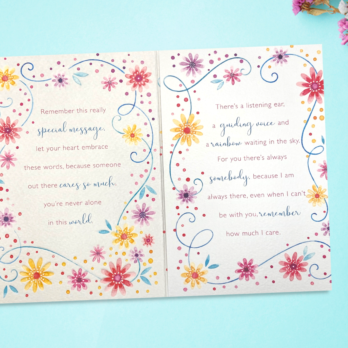 Inside image showing two pages of verse surrounded by watercolour flowers