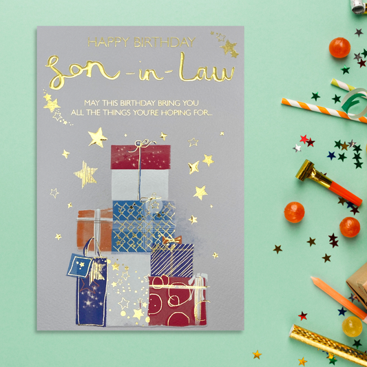 Son In Law card with grey background and multi colour gifts stacked with gold foil stars and text