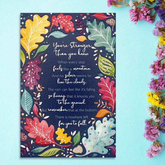 Navy card with bright coloured leaves around border and verse