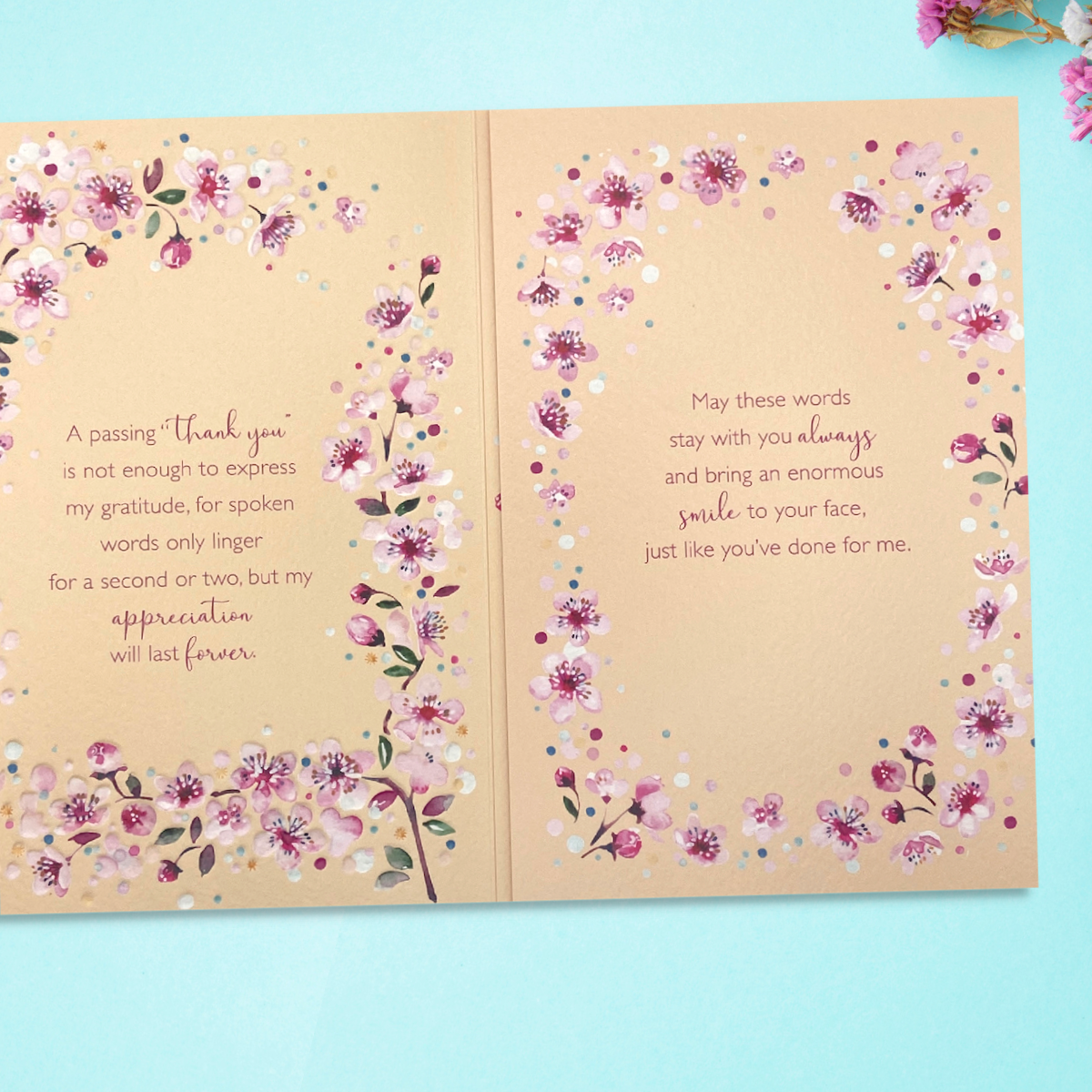 Inside image showing two pages of verse and cherry blossom border