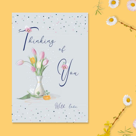 Small grey card with pink white and yellow tulips in vase with dotty border and script text