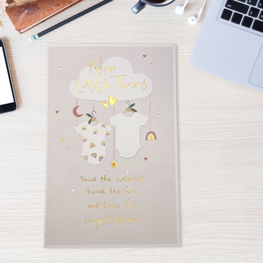 Two hanging vests, a pretty hanging mobile from a cloud and some gold foil text