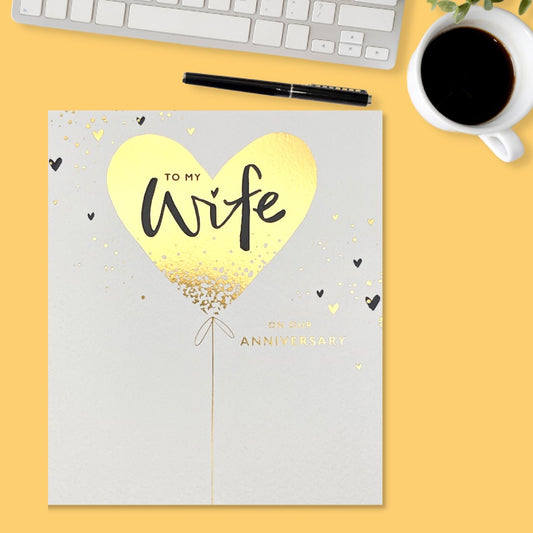 Square white card with gold foil heart balloon and text