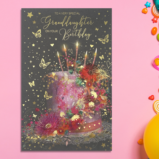 Grey card with bright pink and orange floral cake and candles with butterflies and gold foil details