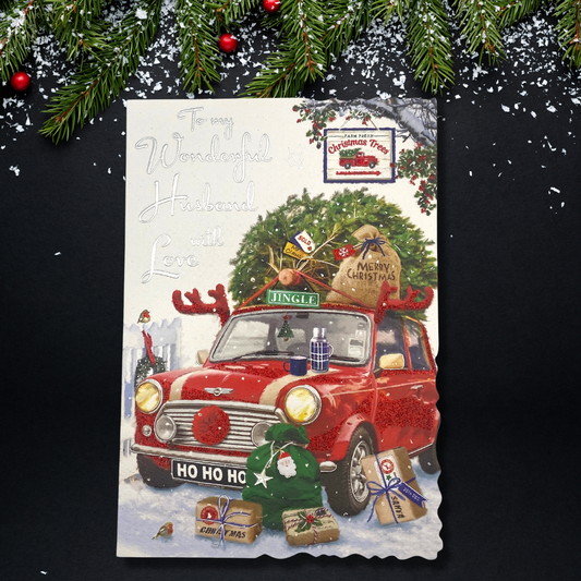 Front image with red mini with christmas tree and gifts in snow