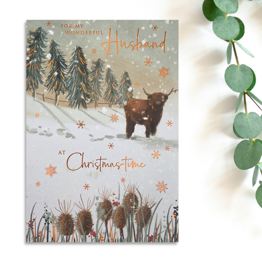 Highland cow in snow with copper foil snowflakes