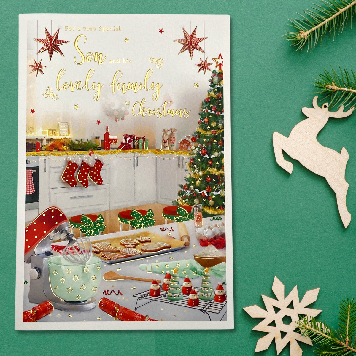 Front image with kitchen decorated scene with christmas tree and stockings