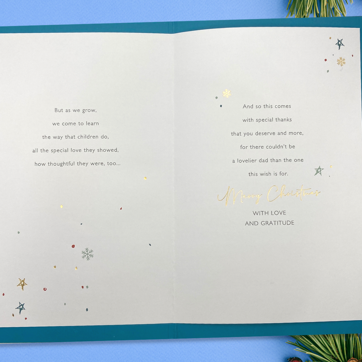 Inside image with teal border and two pages of verse with gold foil details