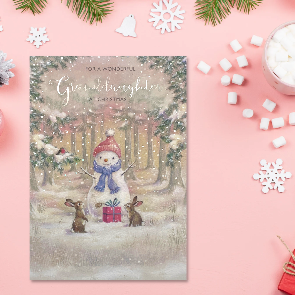 Front image with snowy woodland scene, snowman and bunnies