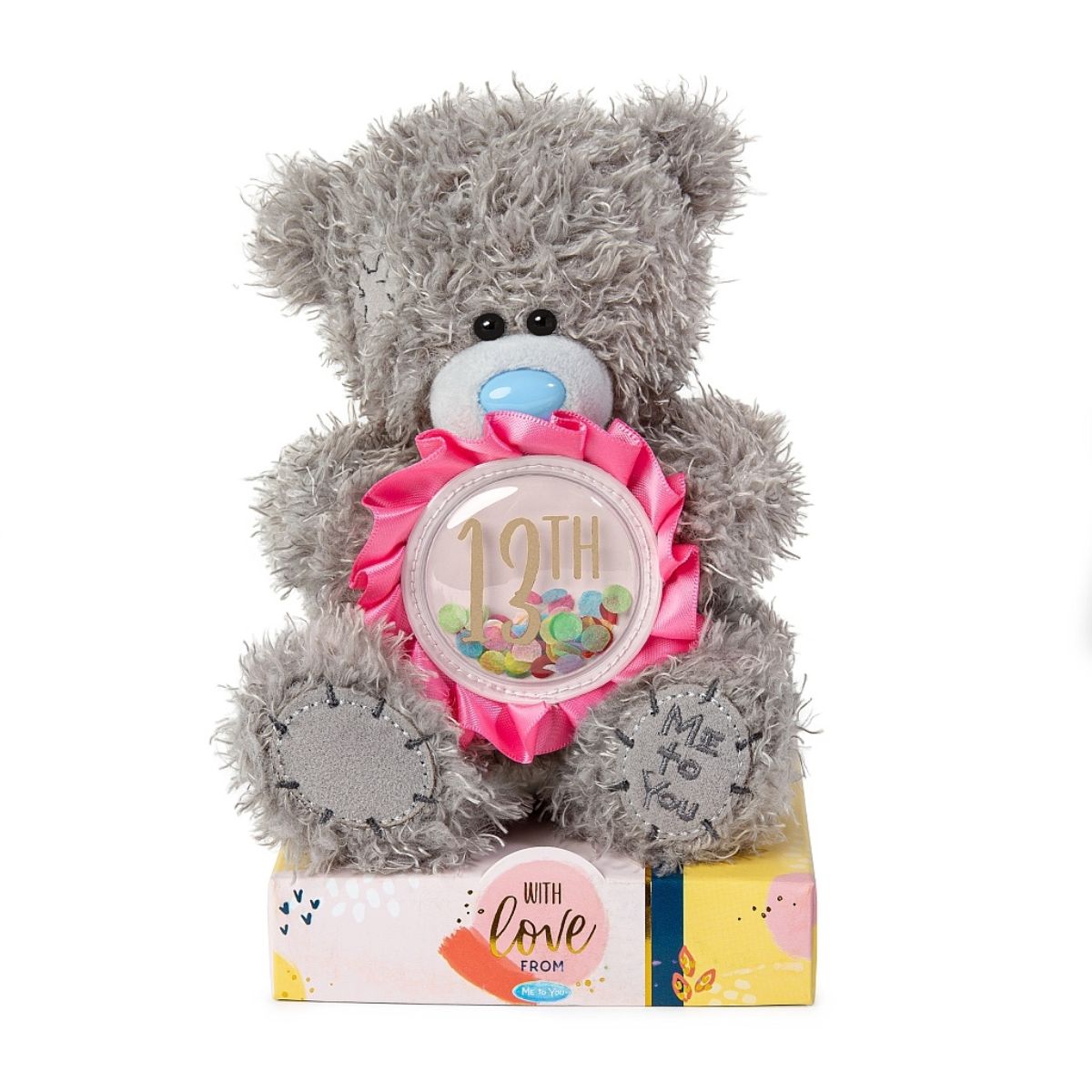 Me To You Bear with grey fur and blue nose sitting on box packaging with text reading With love From. Bear is holding a pink 13th rosette.