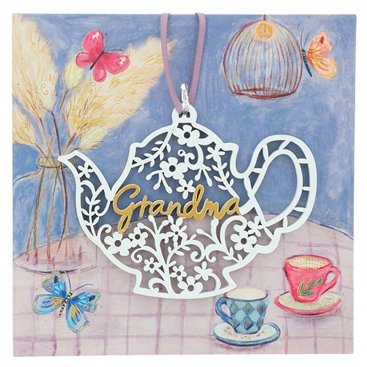 White teapot shaped lace effect hanging plaque on illustrative display card